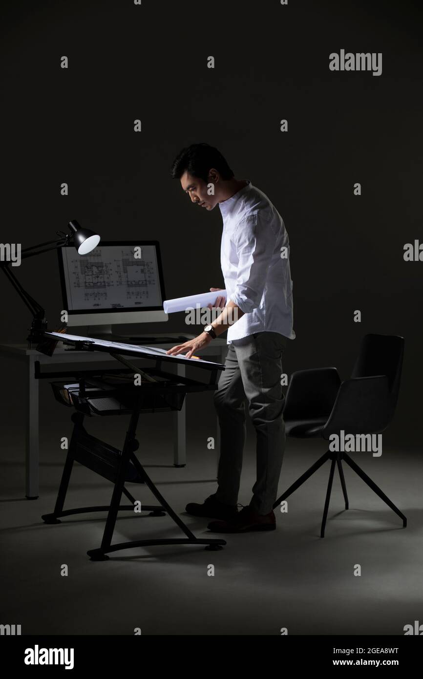 Chinese designer working on construction plan Stock Photo