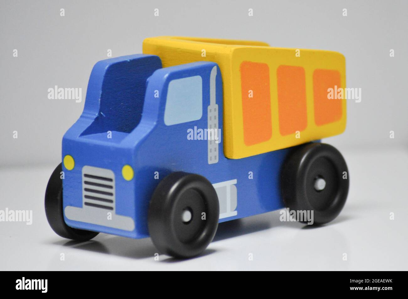 Blue And Yellow Wooden Dumper Truck - Construction Site Toys Against A White Background Image439095599