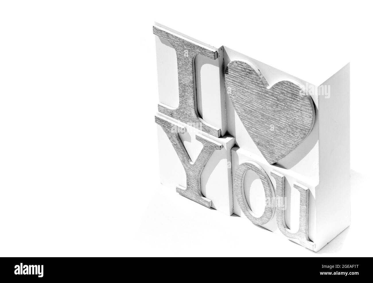 I Love You phrase set on a white tile. The image is against a white background and is in black and white. Copy space is available Stock Photo