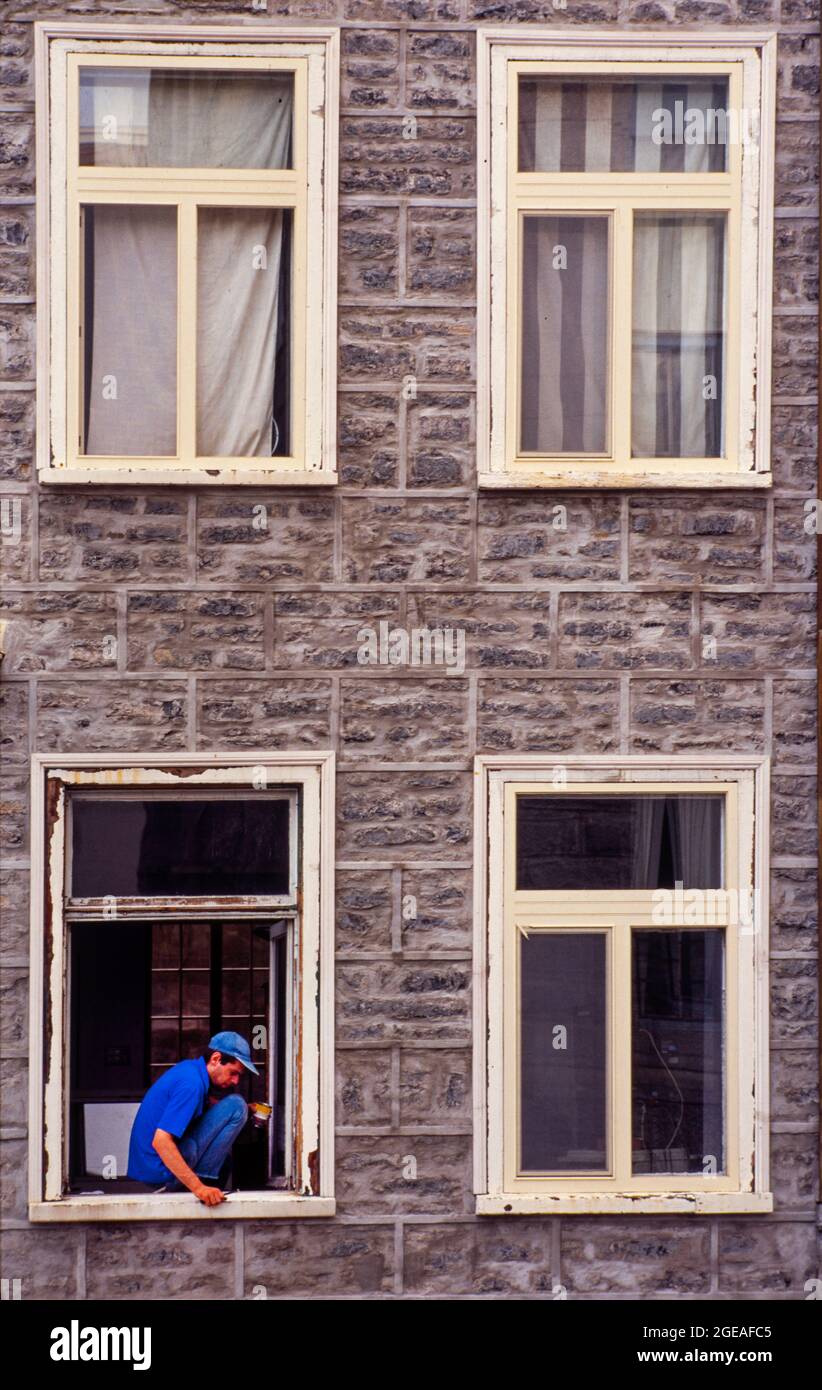 repair man fixing window in building Quebec City Canada Stock Photo - Alamy