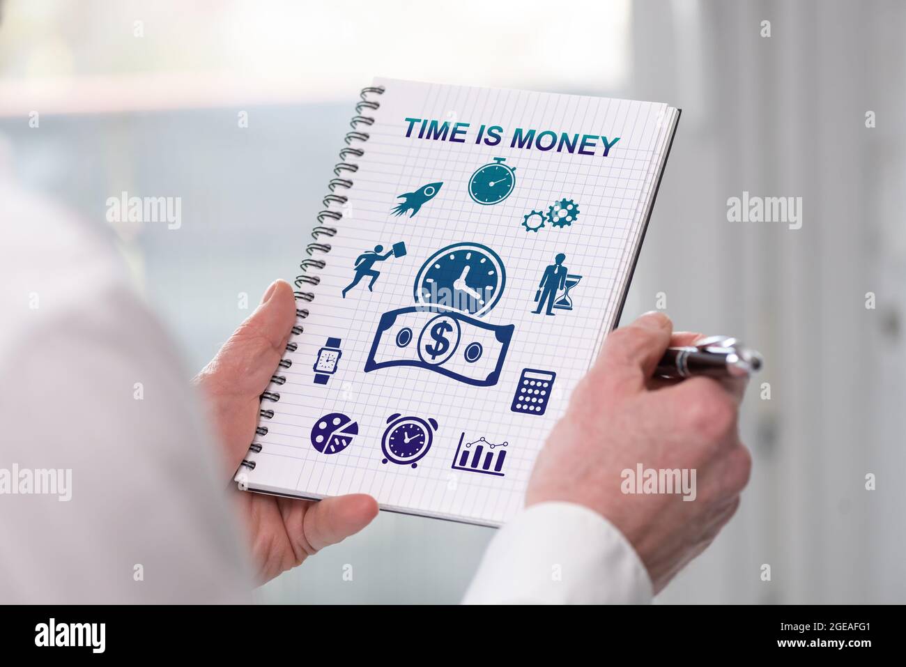 Hand holding a notepad with time is money concept Stock Photo - Alamy