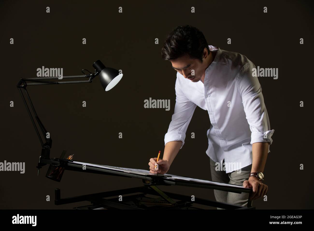 Chinese designer working on construction plan Stock Photo