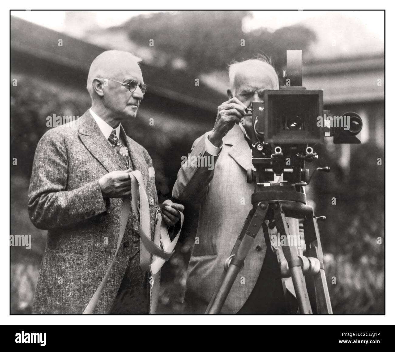 George Eastman founder and visionary of The Easman Kodak Company with Thomas Edison fellow visonary and inventor George Eastman and Thomas Edison  In July 1928, George Eastman and Thomas Edison introduced their color motion picture film to the world.  Inventor Thomas Edison and George Eastman pose for a portrait with a motion picture camera and film at Eastman's house in 1928 in Rochester, New York. USA Stock Photo