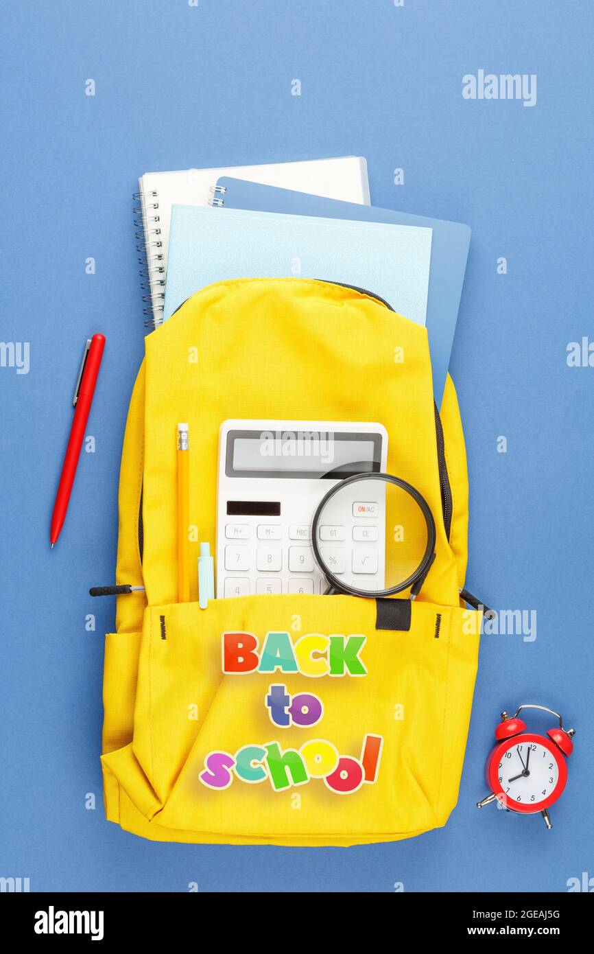 School backpack with stationery on the desk. Stock Photo