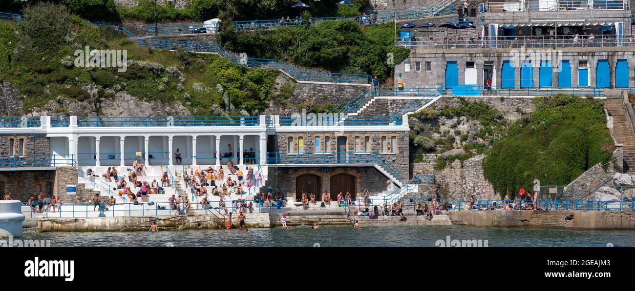 Plymouth, Devon, England UK. 2021. Sunbathers at the Inside Lido on the seafront in Plymouth. Stock Photo