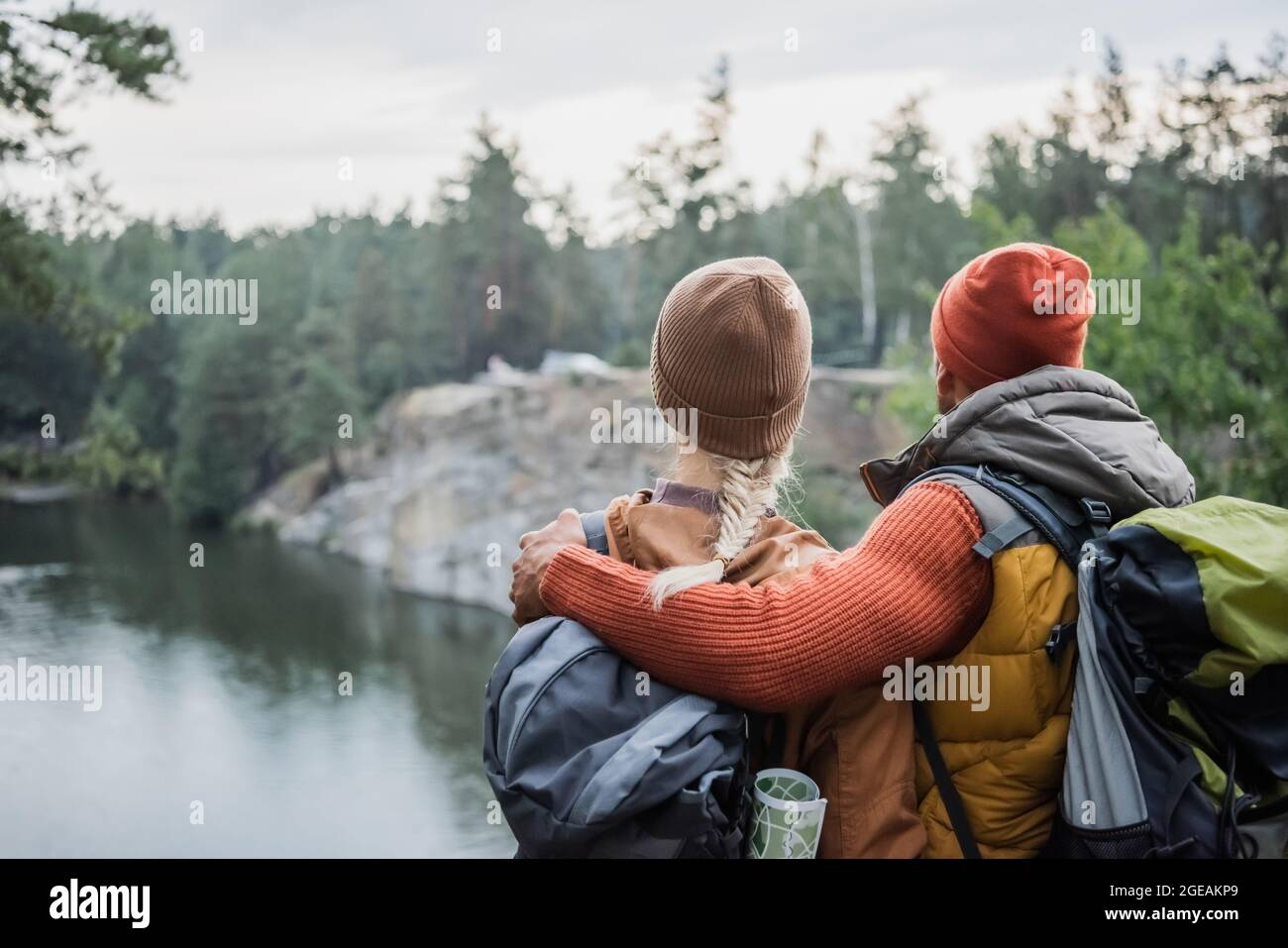 back view of man hugging woman near lake Stock Photo - Alamy