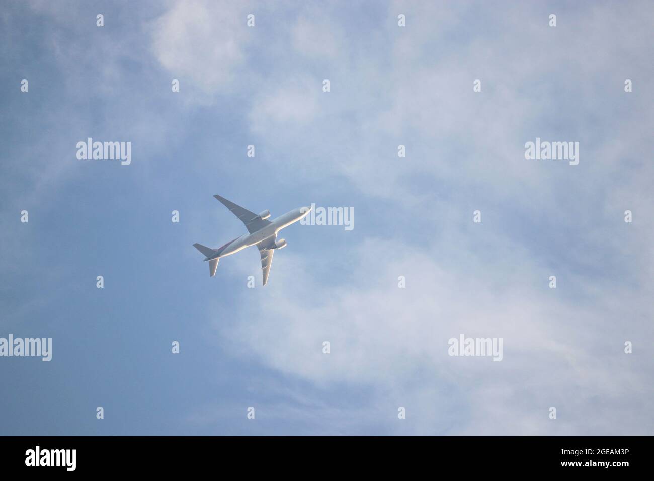 Airplane flying in the blue sky with white clouds. Passenger plane at ...