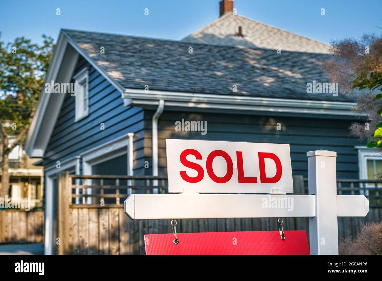 Sold sign in front of wooden house in Canada Stock Photo