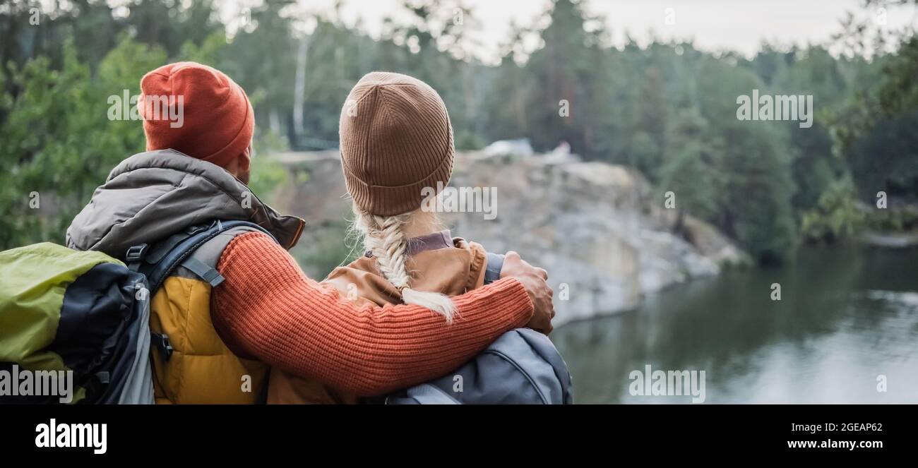 back view of man hugging woman near lake, banner Stock Photo - Alamy