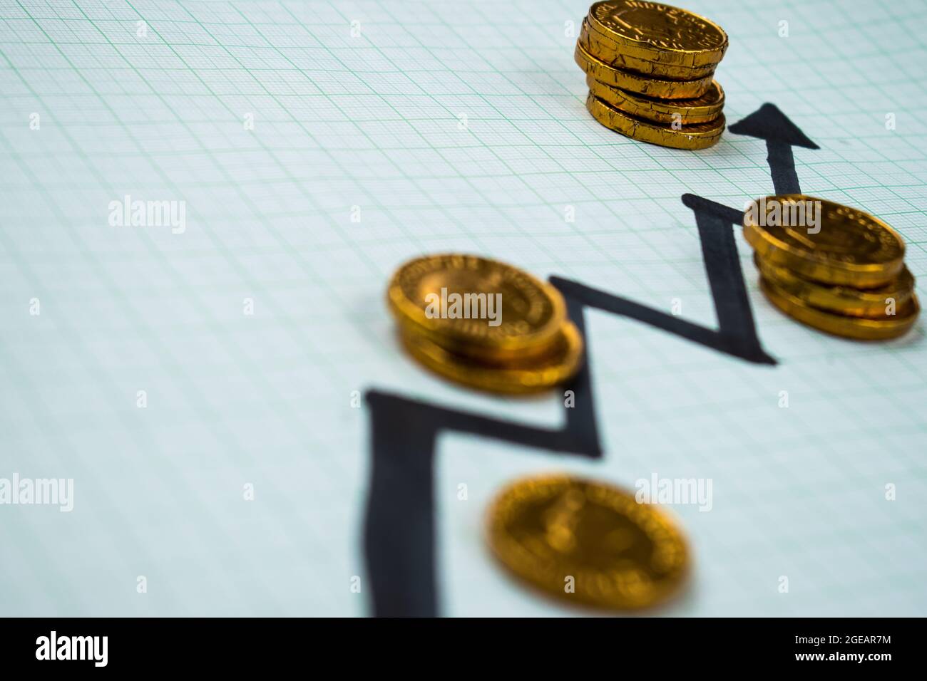 Some golden coins on a background with an economy symbol Stock Photo