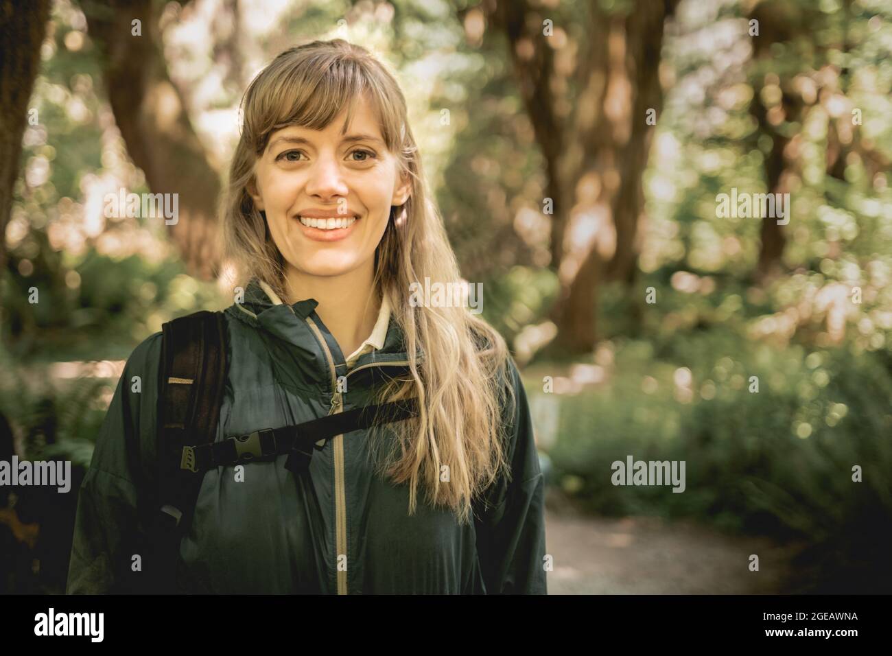 Portrait of young woman hiking in the Hoh Rainforest in Olympic National Park. Stock Photo