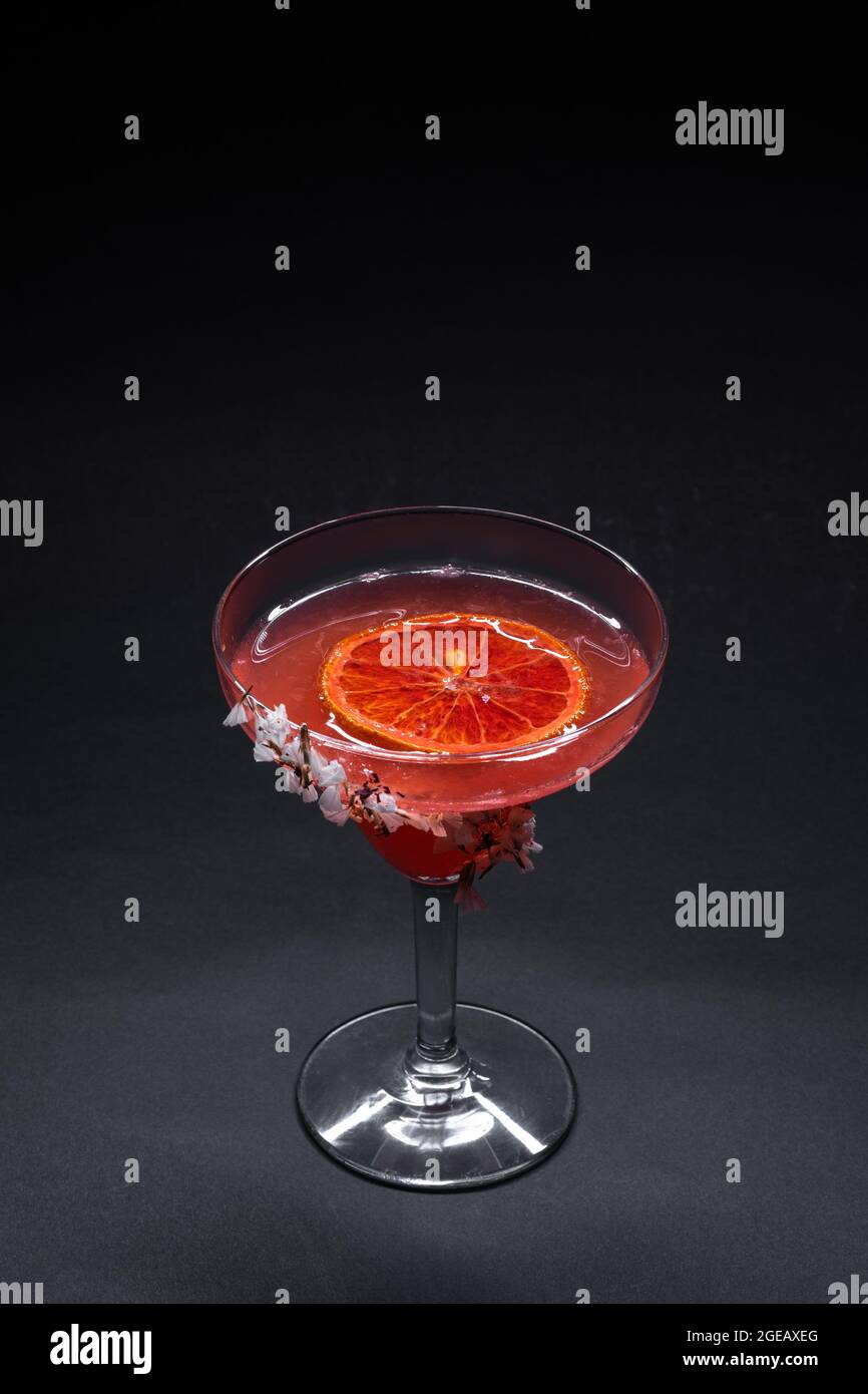 hemingway daiquiri cocktail drink with grapefruit in glass on black