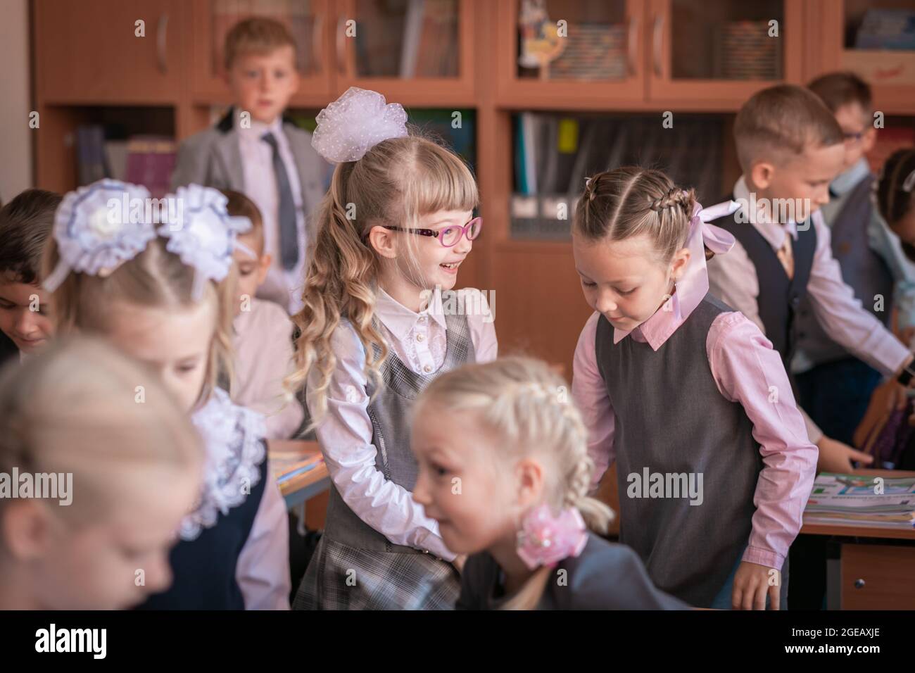 The first grader stands at the desk and answers the teacher's question. Moscow, Russia, September 2, 2019 Stock Photo