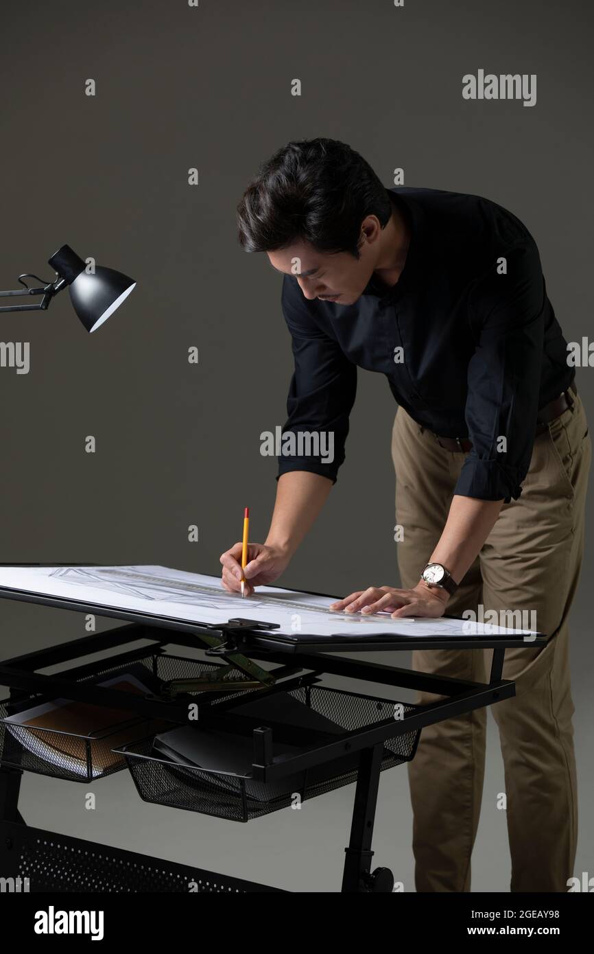 Chinese designer working on construction plan Stock Photo