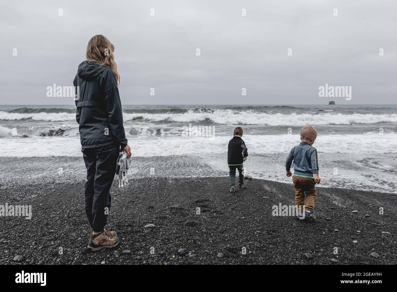 Mother and sons at the water's edge on Rialto Beach in Olympic National Park. Stock Photo