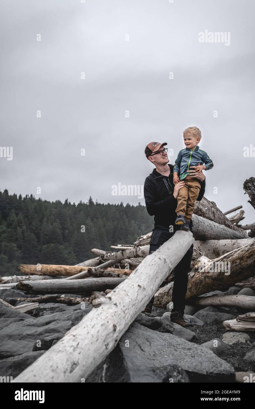 Father playing with son on Rialto Beach in Olympic National Park. Stock Photo