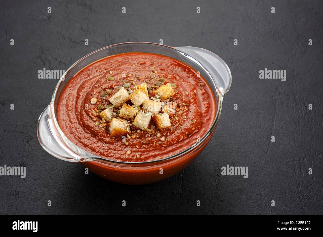 Bowl of tomato soup on black background Stock Photo