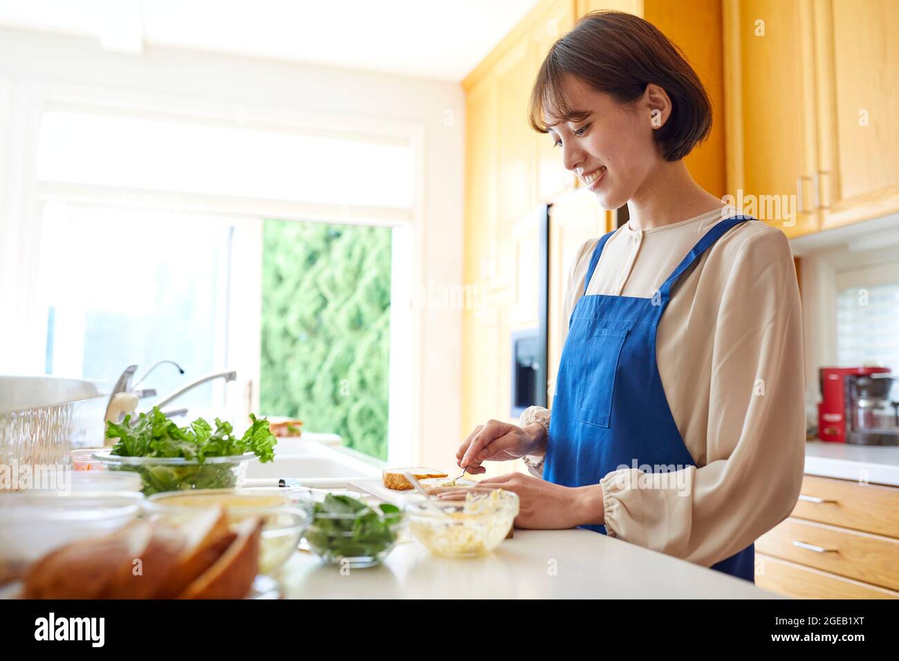 Japanese woman cooking at home Stock Photo - Alamy