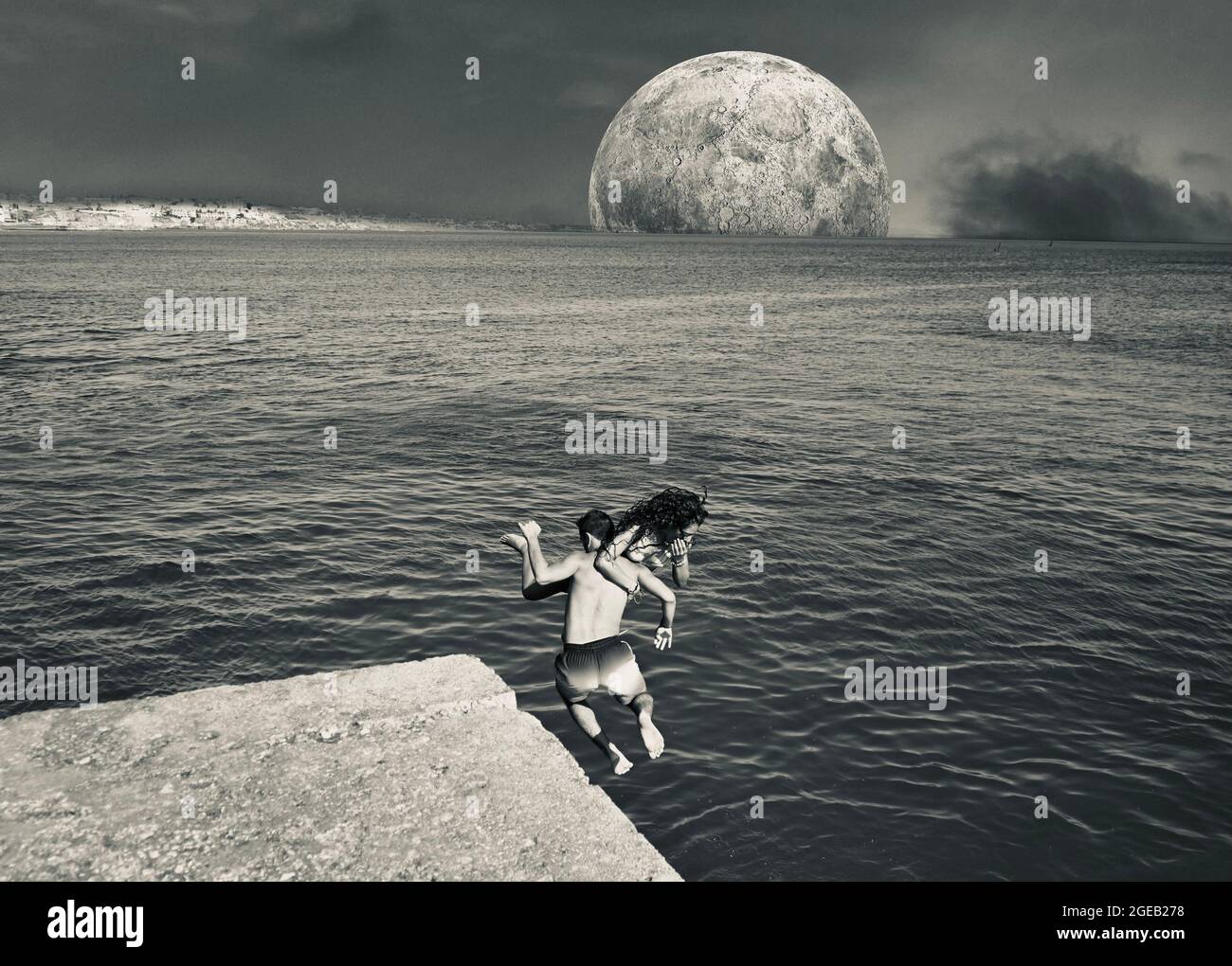 Two people throwing themselves into the ocean Stock Photo Alamy