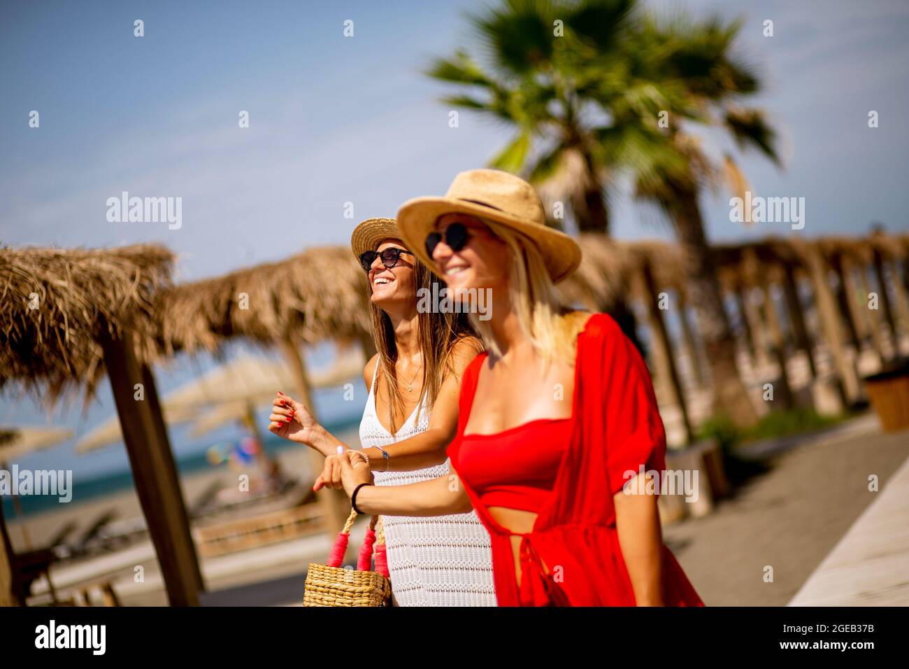 Two woman walking on a beach hi-res stock photography and images - Alamy