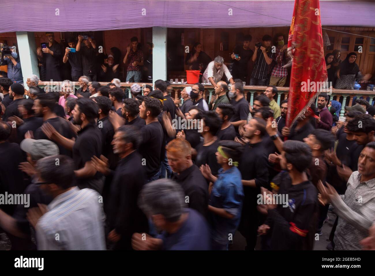 Srinagar, India. 18th Aug, 2021. Kashmiri Shia Muslims walk while ...