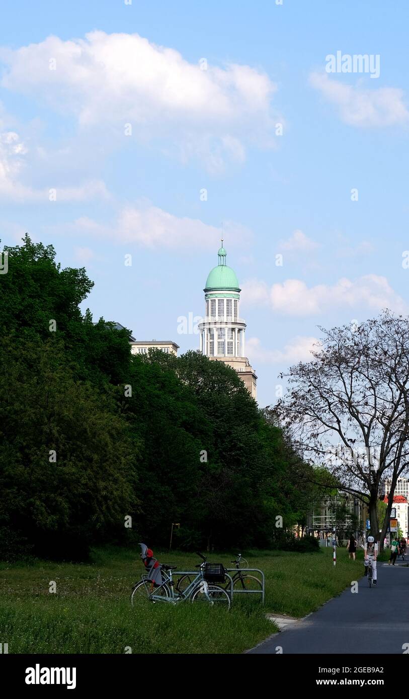 Berlin, Germany, 25 April 2021, domed tower at Frankfuter Tor with old trees at the end of Karl-Marx-Alle in Friedrichshain. Stock Photo