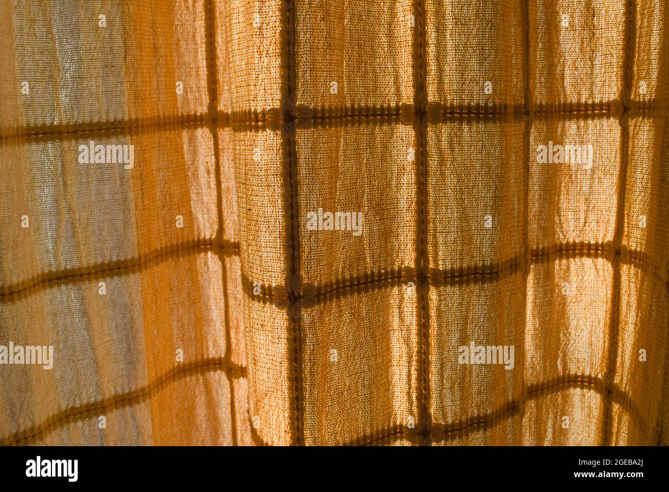 Door curtains with semi transparent thin cloth textile fabric with square pattern design. Morning sunglight drapes indian house interiors Stock Photo