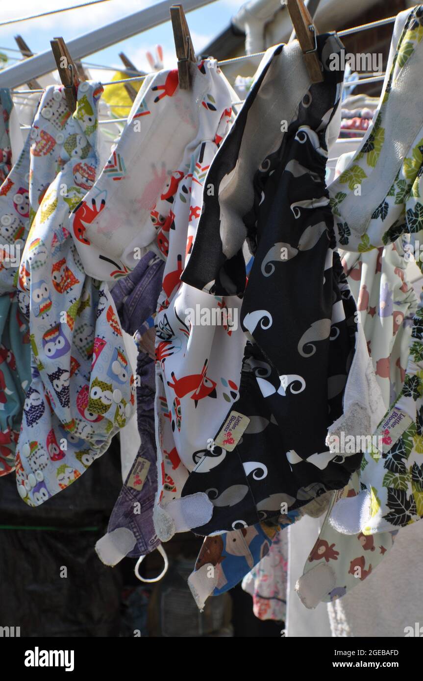 Reusable pocket nappies drying on a washing line Stock Photo