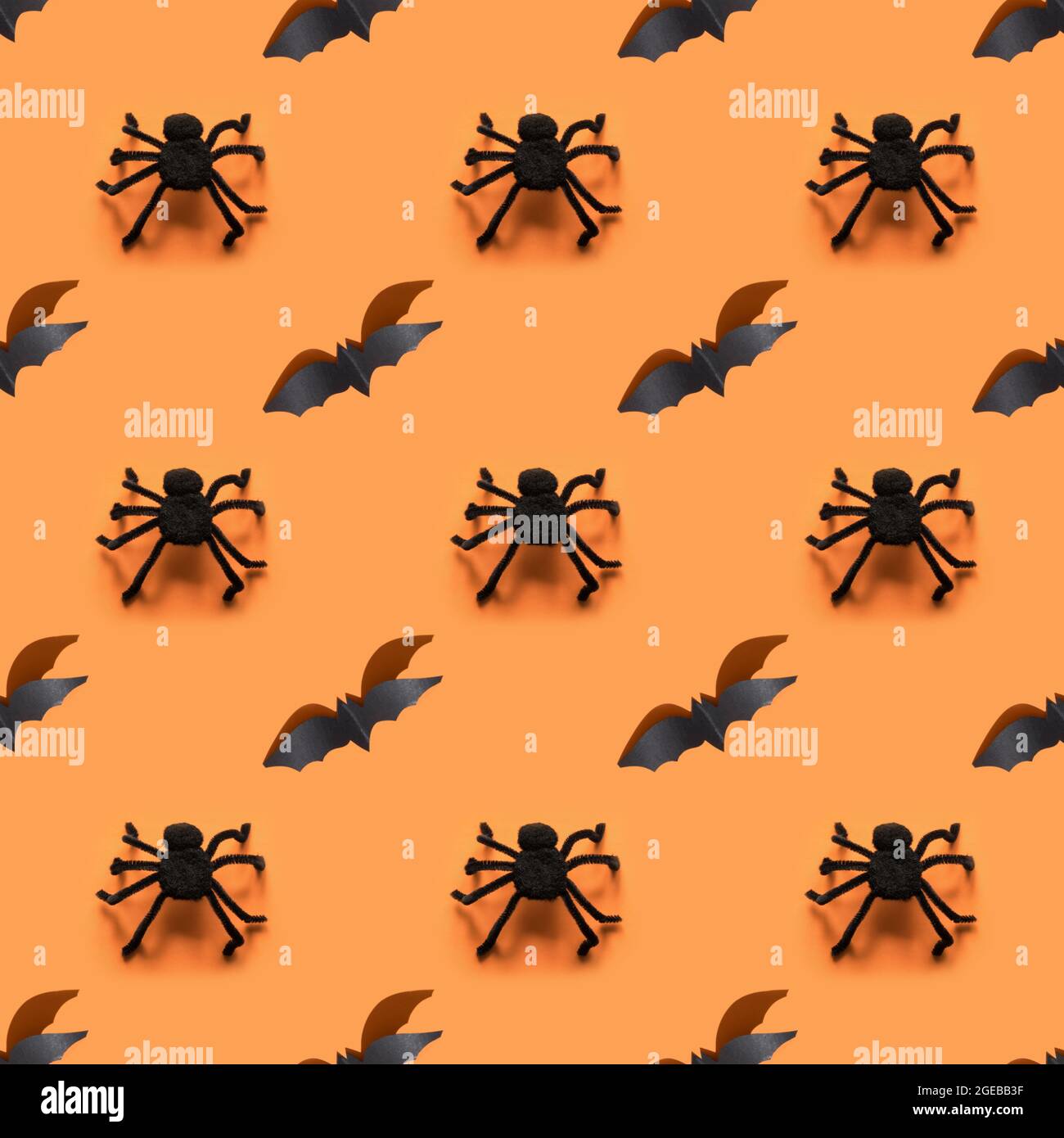 Seamless Halloween pattern of black bat and spiders on orange ...