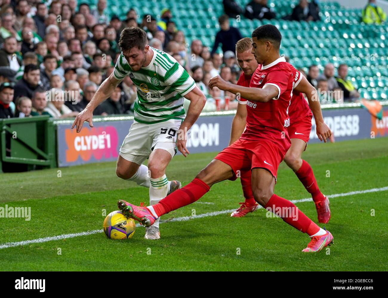 Celtic's Anthony Ralston (left) battles for the ball with AZ Alkmaar's Dani de Wit (back) and Zakaria Aboukhlal during the UEFA Europa League Play-off, first leg match at Celtic Park, Glasgow. Picture date: Wednesday August 18, 2021. Stock Photo