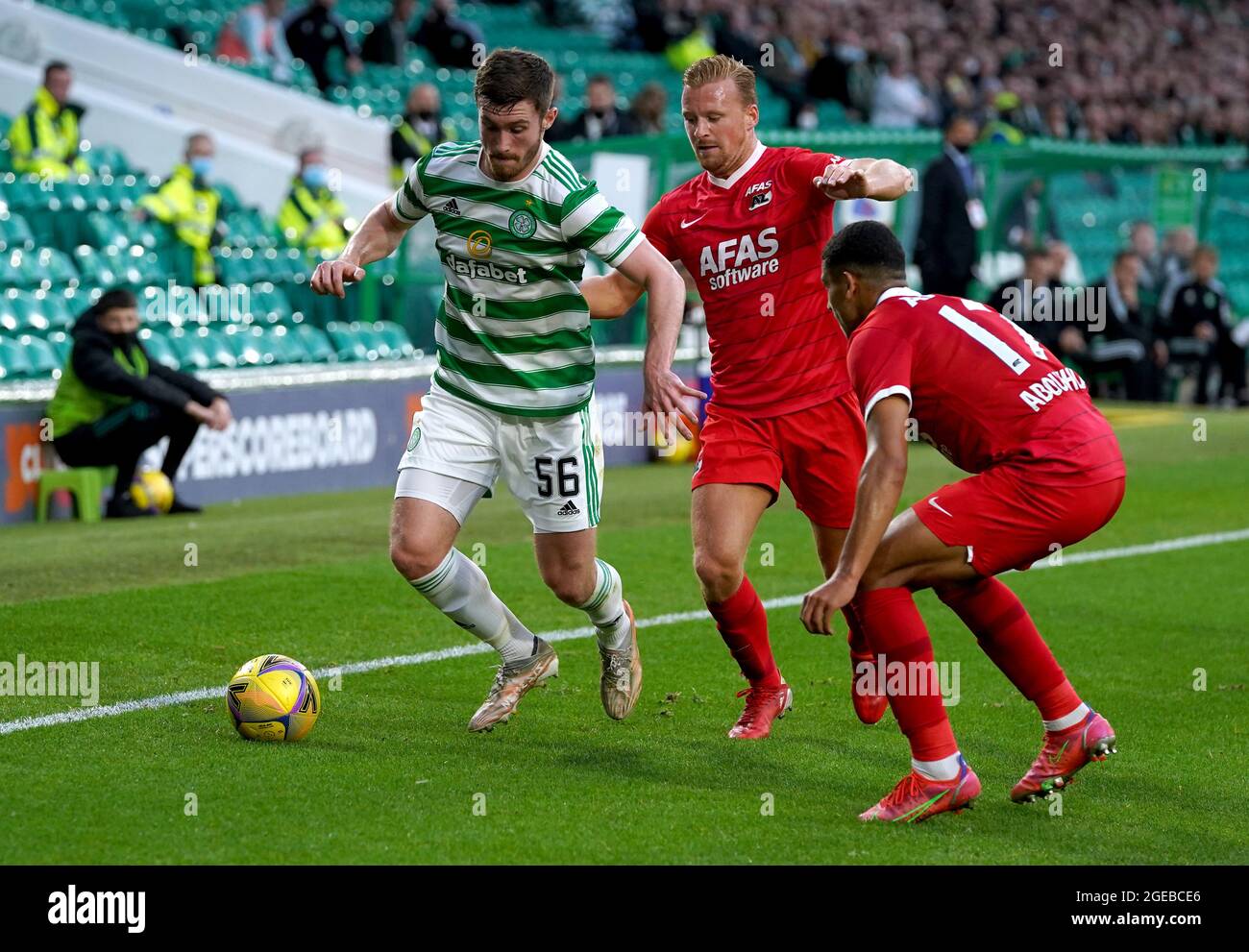 Celtic's Anthony Ralston (left) battles for the ball with AZ Alkmaar's Dani de Wit (centre) and Zakaria Aboukhlal during the UEFA Europa League Play-off, first leg match at Celtic Park, Glasgow. Picture date: Wednesday August 18, 2021. Stock Photo