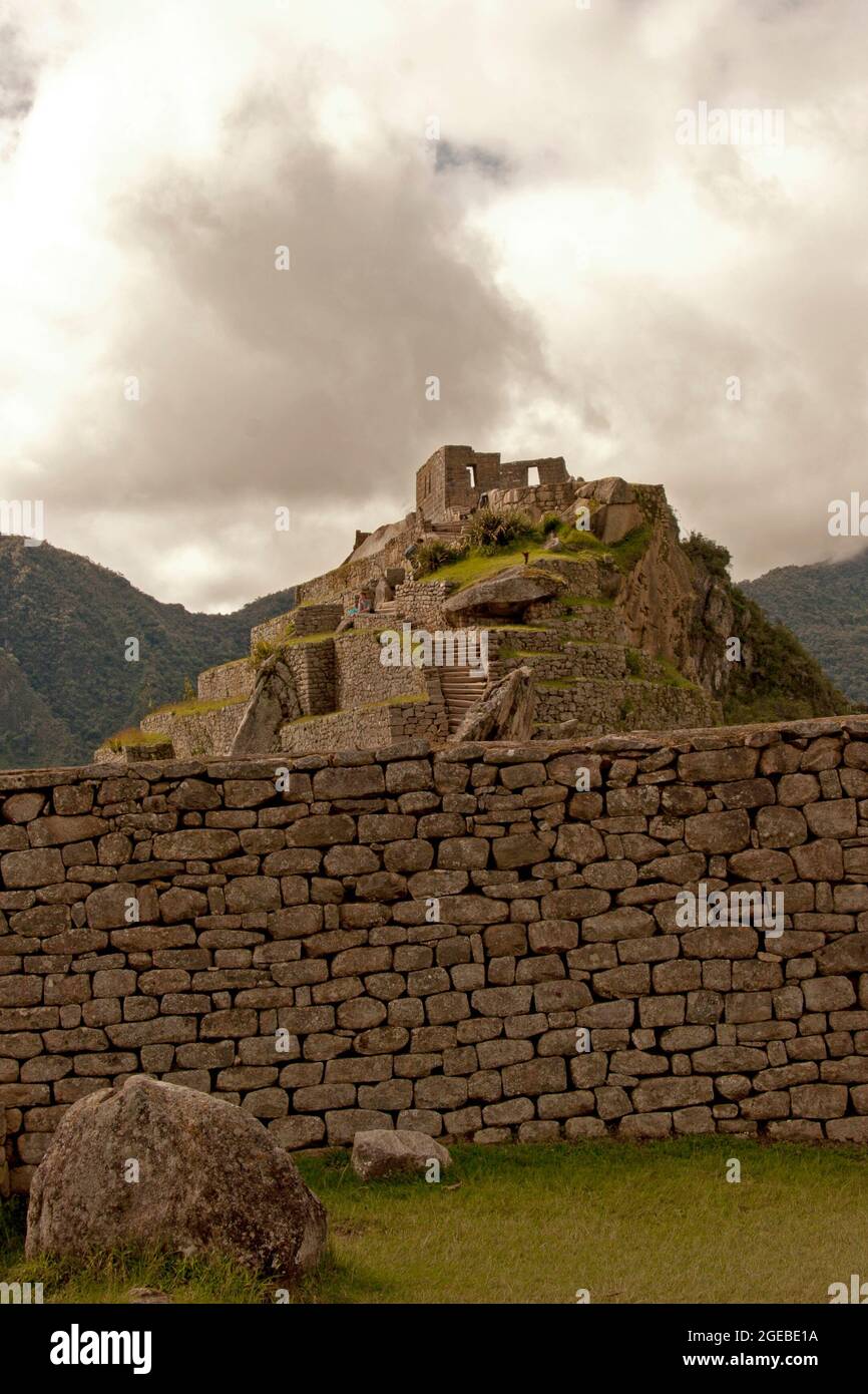 Machu Picchu hill top house with stone wall foreground Stock Photo - Alamy