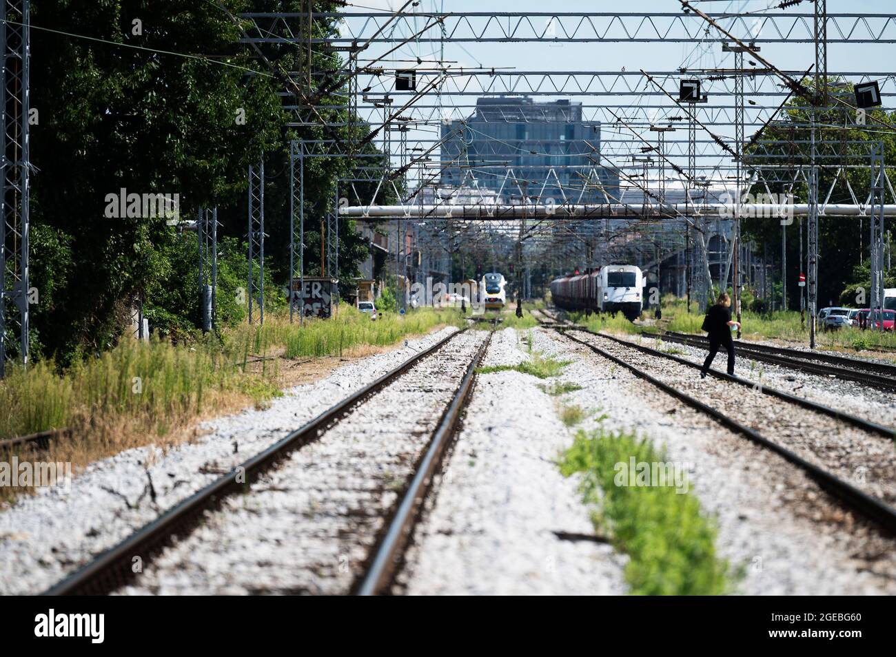 Person crossing the railway tracks in Zagreb, Croatia Stock Photo
