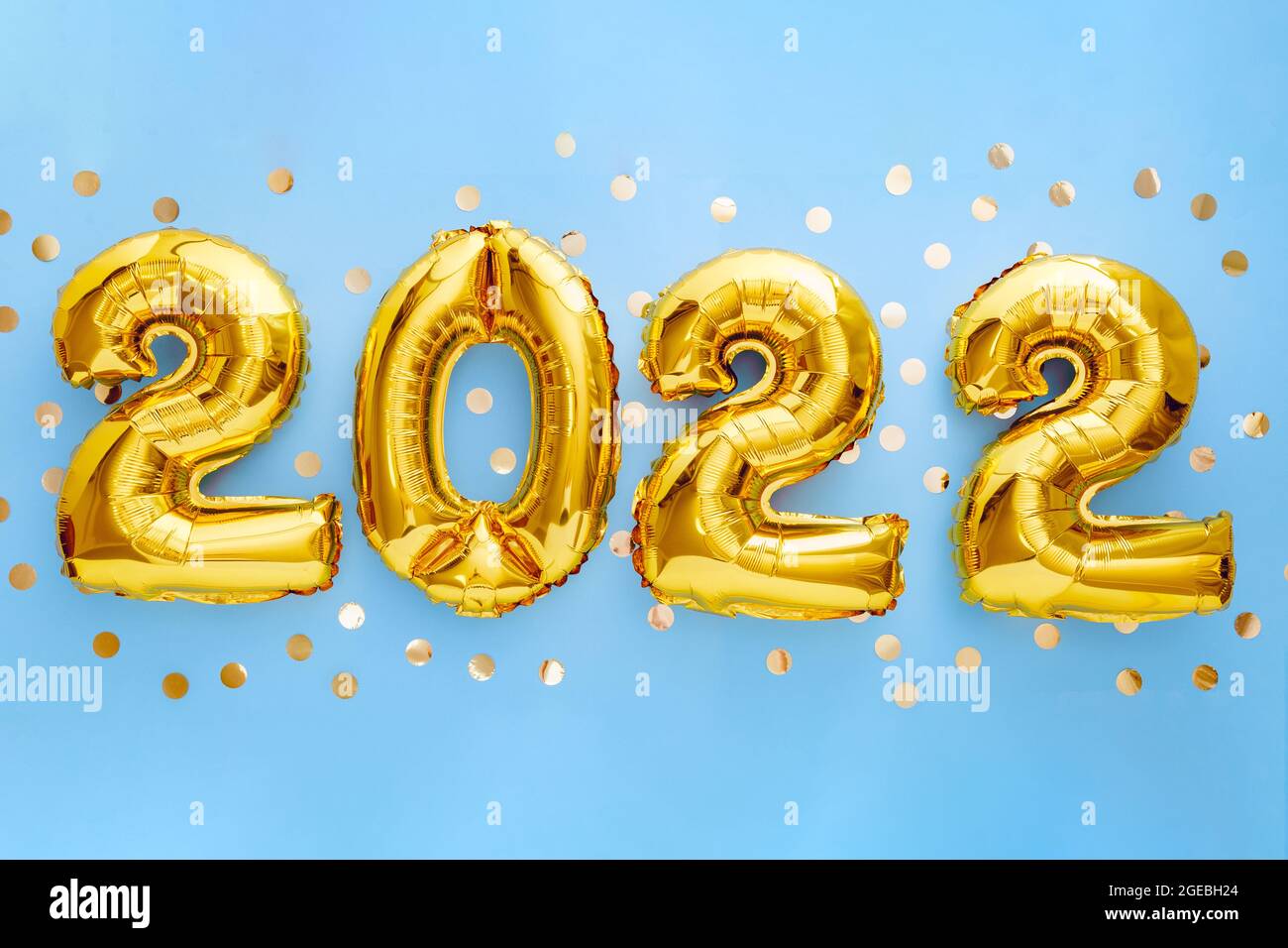 2022 gold foil balloons calendar. 2022 numeral balloon gold text Happy New year eve invitation with Christmas on Blue background with golden confetti Stock Photo