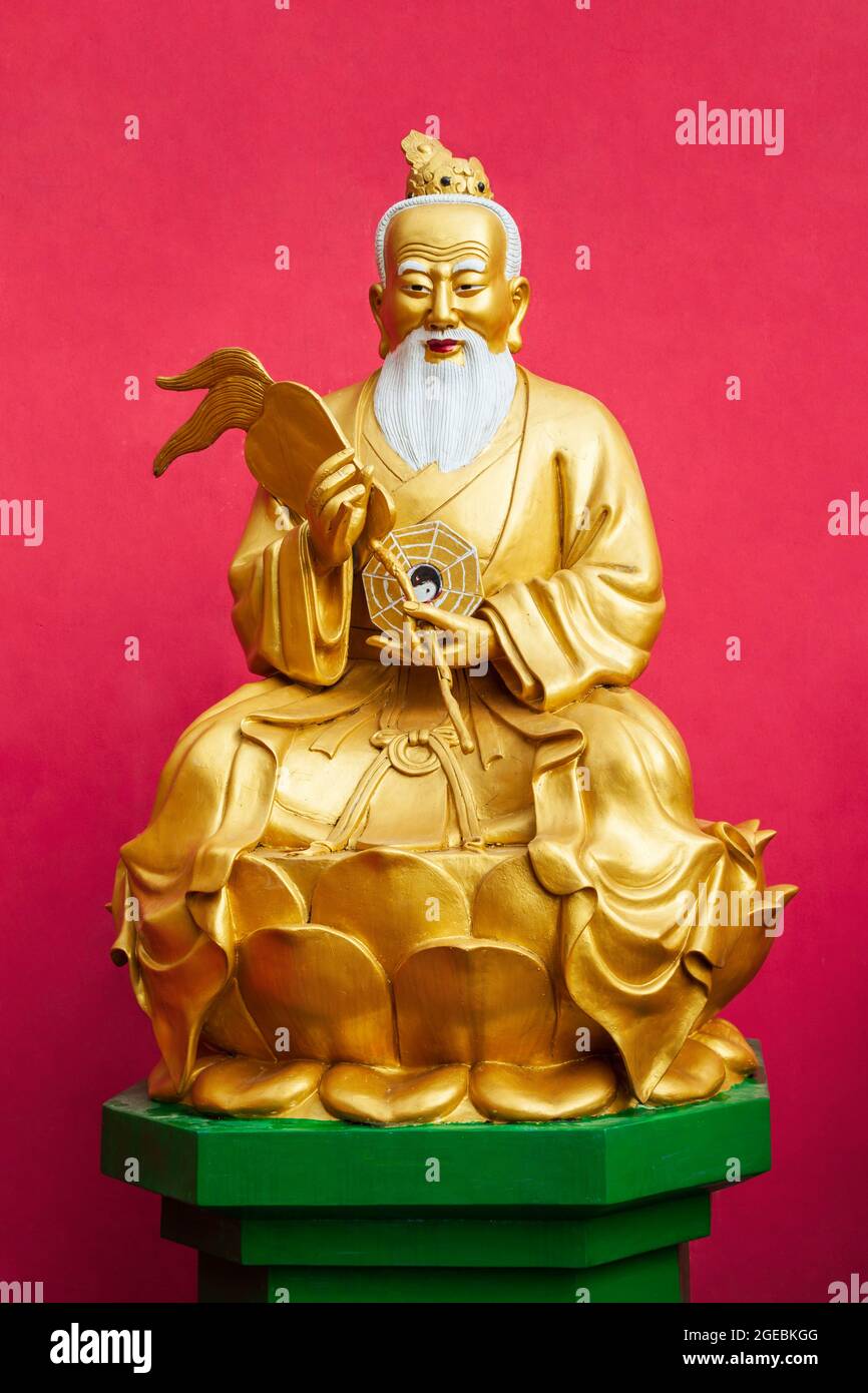 Old wise chinese monk golden statue at the Ten Thousand Buddhas Monastery or Man Fat Sze, a buddhist temple located in Hong Kong, China Stock Photo