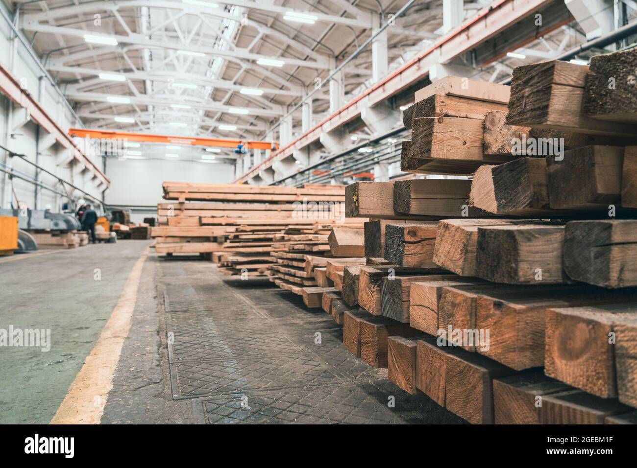 Woodwork factory with stacks of wood and equipment machinery. Professional industrial carpentry manufacturing. Stock Photo