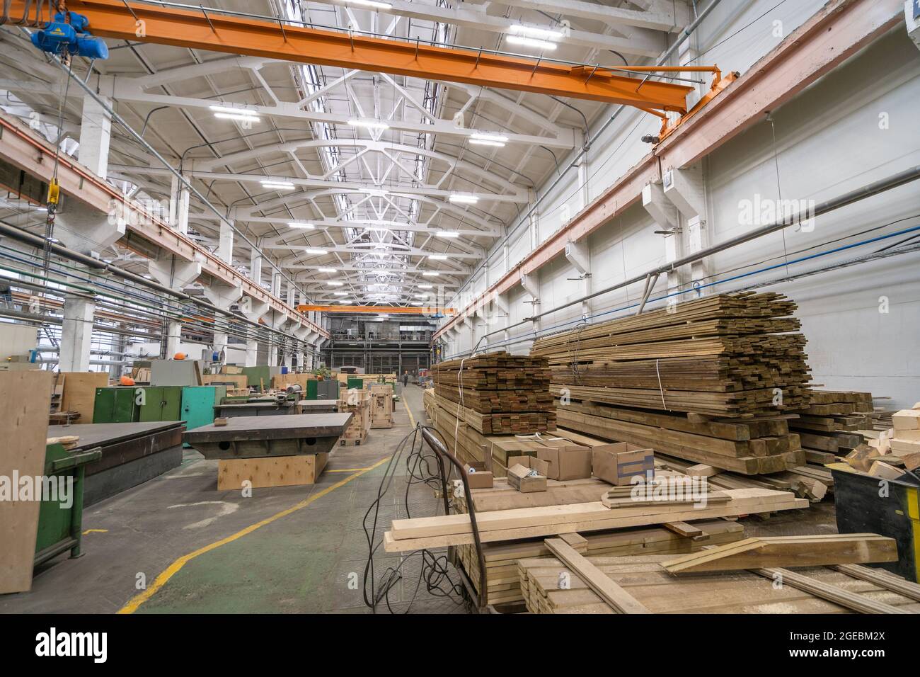 Inside huge factory workshop interior with stacks of wood for making molds. Woodwork manufacture production industry. Stock Photo