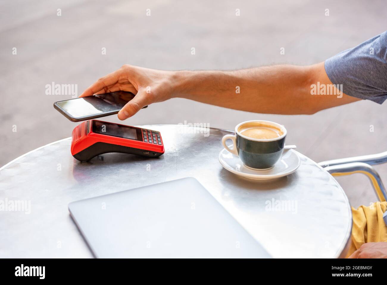 Unrecognizable man paying with mobile phone in the machine Stock Photo