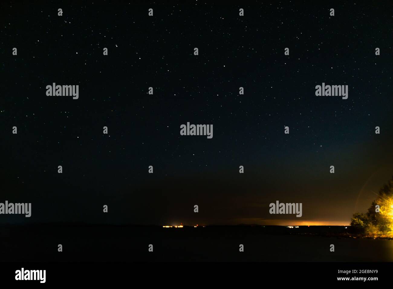 night starry sky and lights from the city Stock Photo