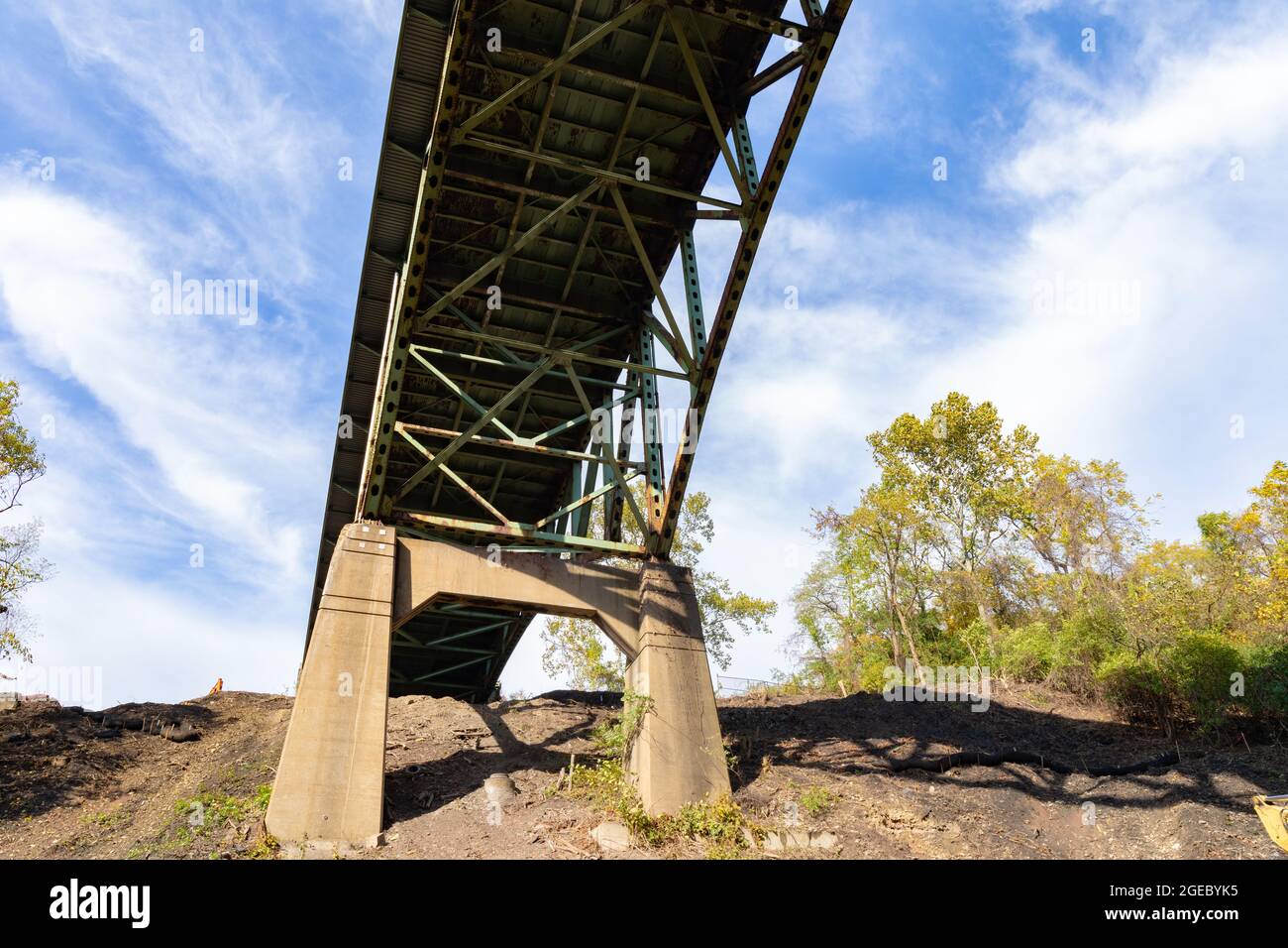 View of the underside of a bridge with peeling paint, heavy rust