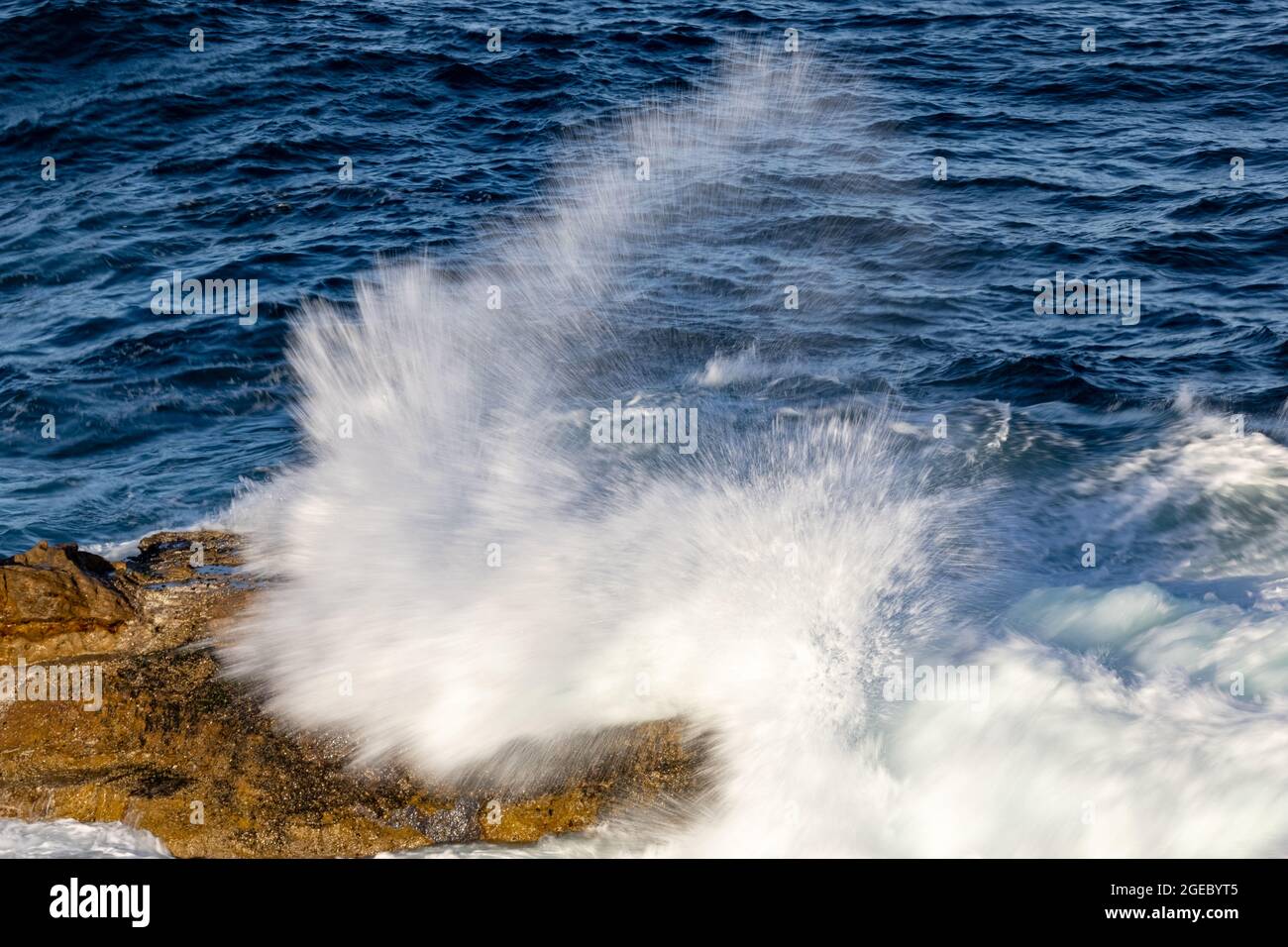 Wave Breaking onto rocky coast line Stock Photo - Alamy