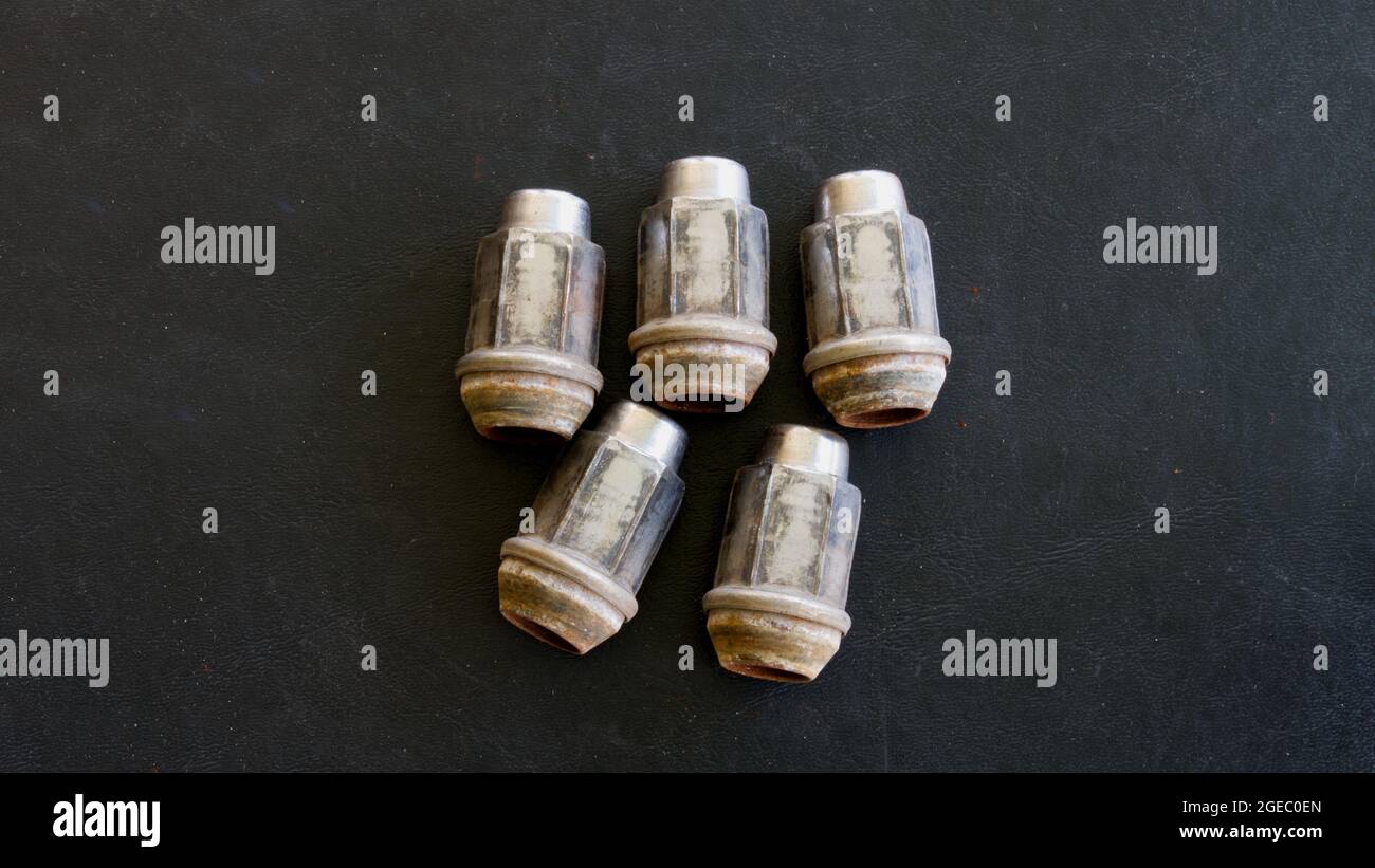 Five Lug Nuts Off of a Vehicle Stock Photo
