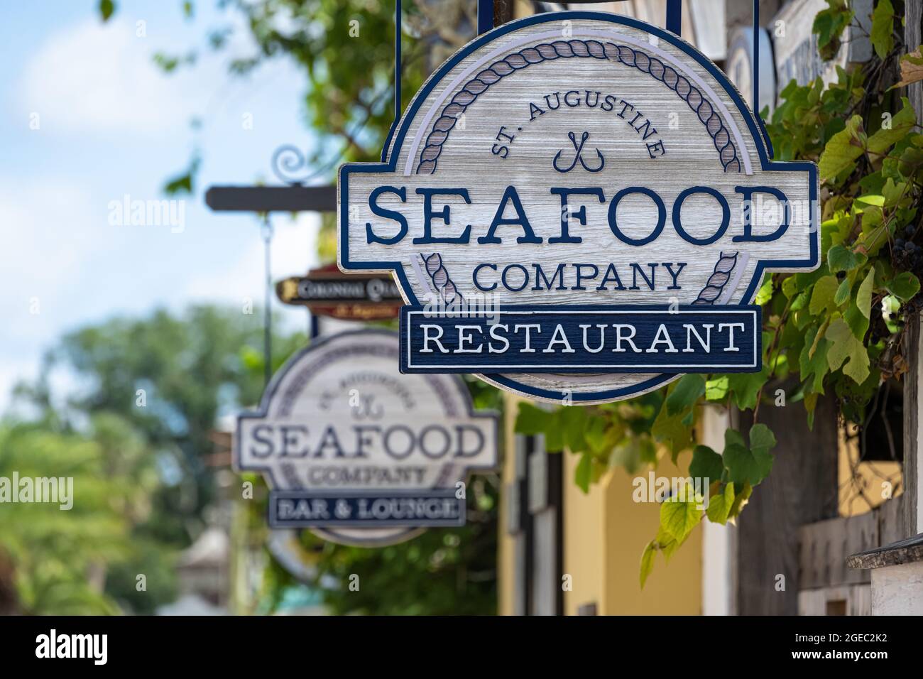 St. Augustine Seafood Company restaurant signs along St. George Street in the Colonial Quarter of Historic Downtown St. Augustine, Florida. (USA) Stock Photo