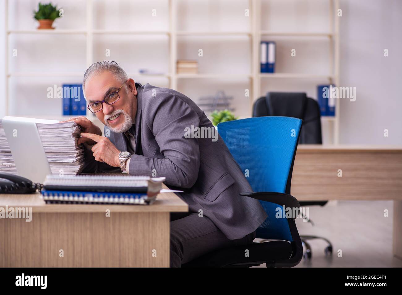 Old businessman employee working at workplace Stock Photo - Alamy