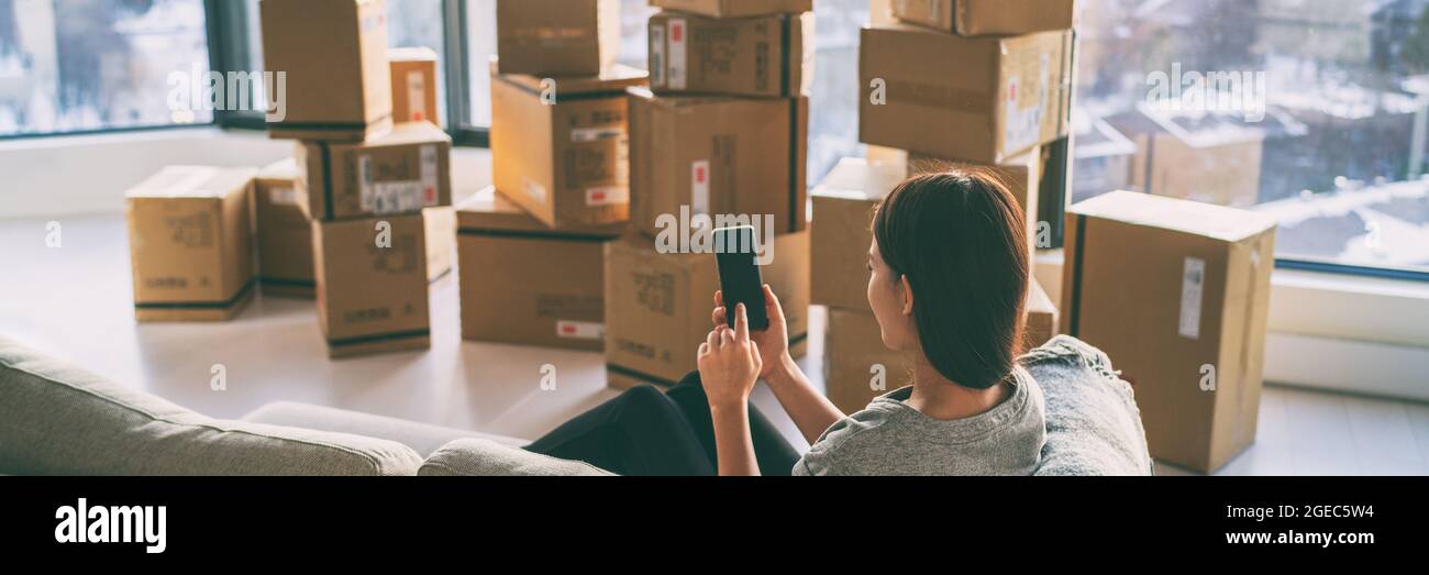 Moving boxes woman using phone panoramic for move to college leaving
