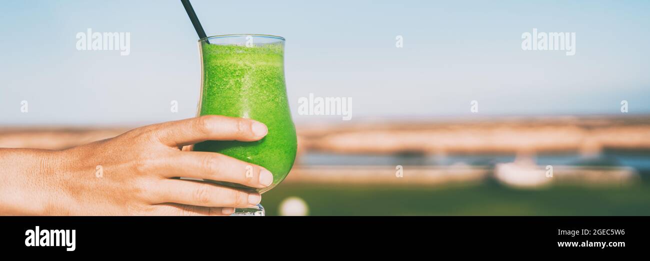 Green juice detox healthy food woman serving or taking smoothie glass of spinach spirulina weight loss. Panoramic banner for healthy eating Stock Photo