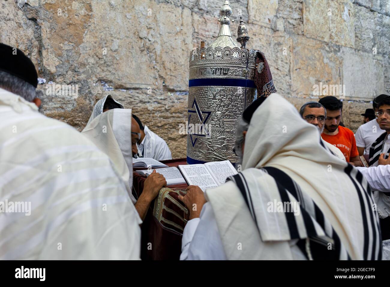 A group of religious Jews praying with a Torah scroll at the Wailing Wall (aka Kotel) commemorating Tisha B'Av in Jerusalem, Israel. Stock Photo