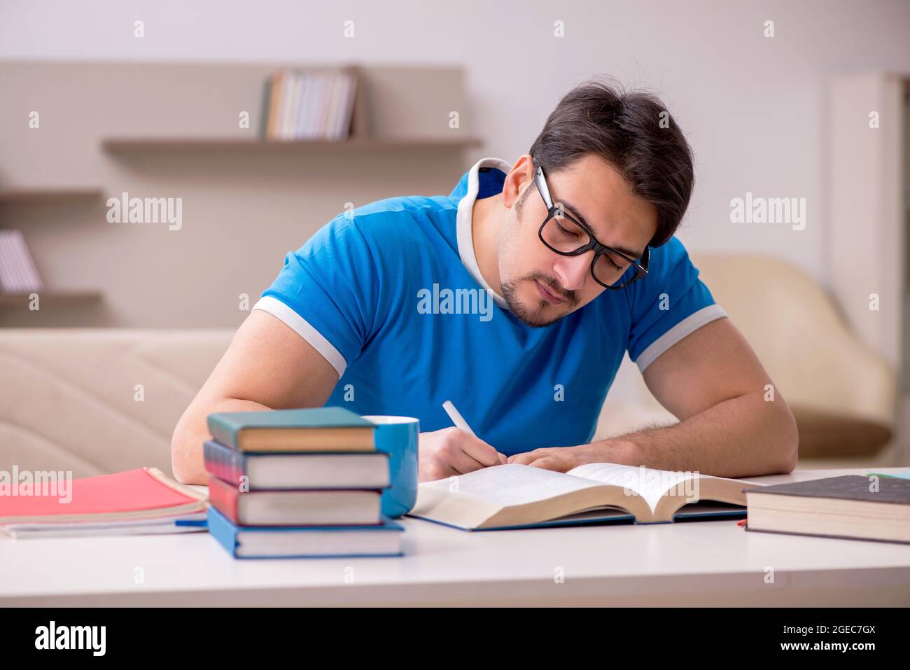 Young student studying at home Stock Photo - Alamy