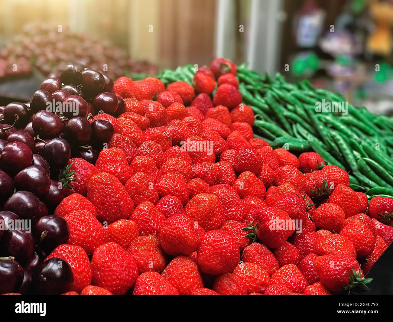 Strawberry, peas, cherries on the counter in the store Stock Photo Alamy