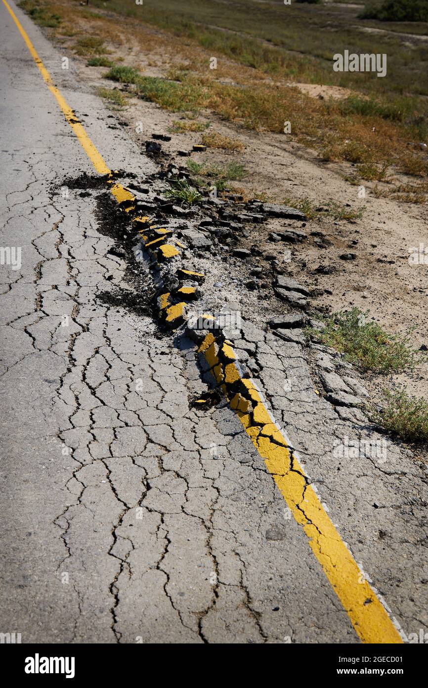 Destroyed roadside of country highway. Poor condition requires repair Stock Photo